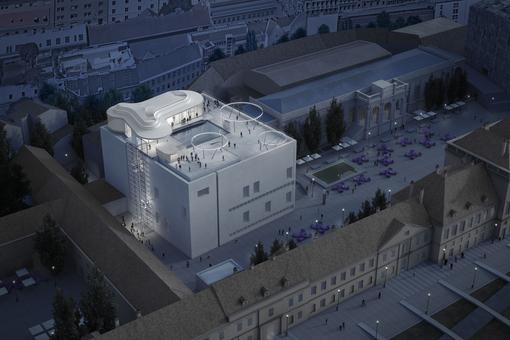 The photo shows the illuminated MQ dragonfly on the roof of the Leopold Museum in the evening.