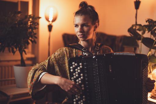 Photo of a young woman playing an accordion