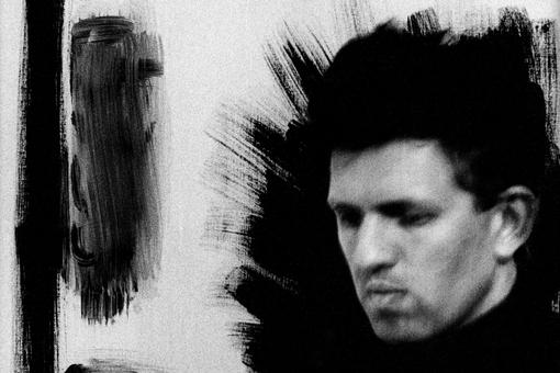 The edited black and white photo shows a self-portrait by Anton Corbijn with closed eyes