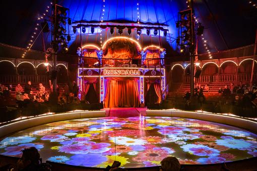Foto der bunt beleuchteten Manege des Circus Roncalli