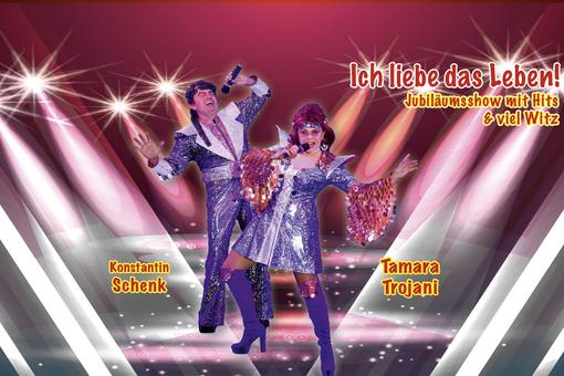Das Plakat zur Show mit den beiden Künstler:innen in lila glitzernden Köstümen im Stile der 1970er Jahre