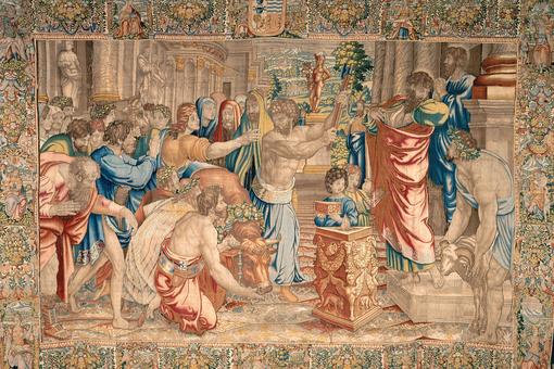 The photo shows an elaborate tapestry depicting the Biblical scene of the sacrifice of Lystra