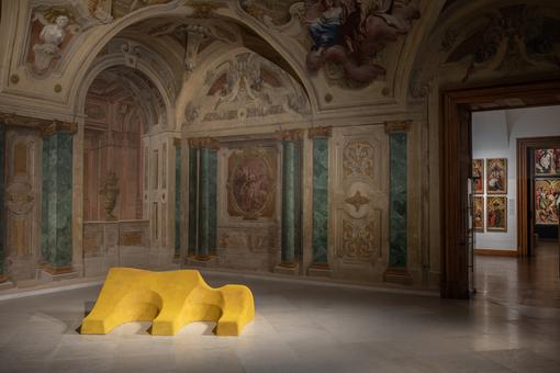 Installation view "Lena Henke. Aldo Rossi's Sleeping Elephant": abstract yellow elephant lying on the floor of an exhibition hall