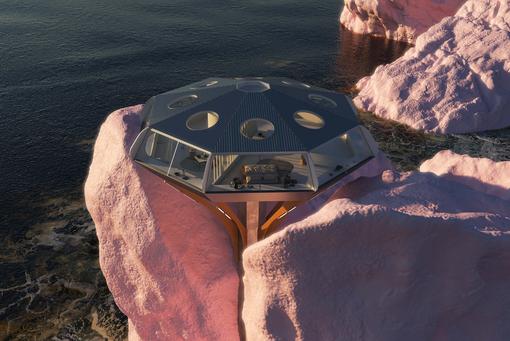 Foto einer futuristisch anmutenden Metall-Glaskonstruktion, die wie eine Ufo, das auf rosa Felsen am Meer gelandet ist, aussieht