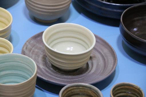 Photo of ceramic tableware in gray, beige and light turquoise colors