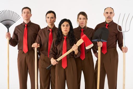 Photo shows five actors, all wearing brown pants and shirts, with red ties, holding gardening tools such as hoes, shovels and pitchforks