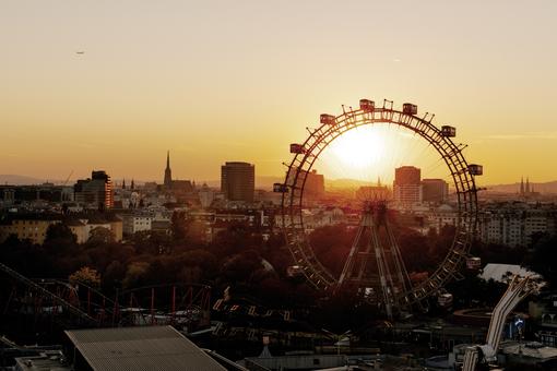 Photo of the Vienna Giant Ferris Wheel and part of Wurstelprater in the glow of the setting sun