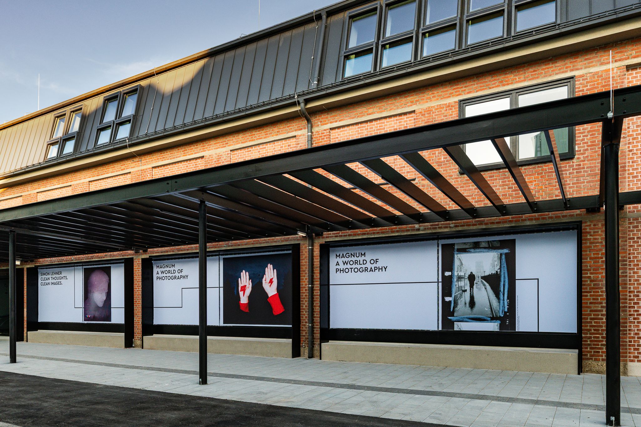 @ Michael Seirer Photography The photo shows an exterior view of the Foto Arsenal Wien with photo posters announcing the upcoming exhibitions